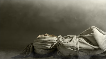 Pocong on the ground with a fog background. A traditional ghost from Indonesia that takes the form of a human wrapped in a shroud or winding sheet. Concept of Halloweenの写真素材