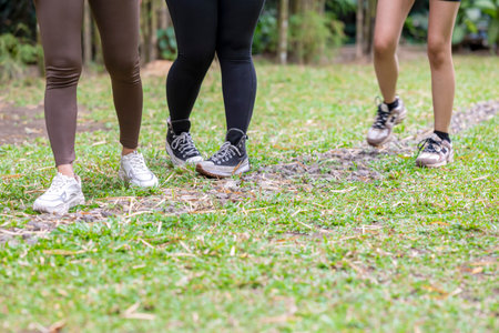 People in a sporty outfit walking together in a public park outdoors. Concept of a Healthy active lifestyleの写真素材