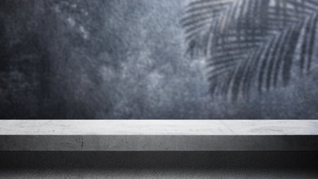 Minimalist stage or podium display with a shadow of a palm leaf on a black background. Product presentation, mockup, copy space, and templateの写真素材