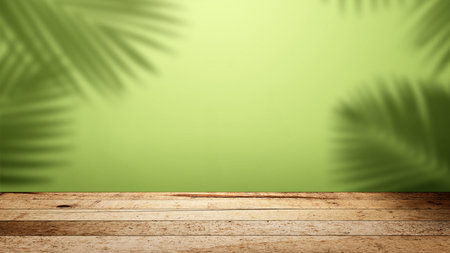 Interior of a modern and minimalist studio with the shadow of a palm leaf on a green wall with a wooden floor background. Mockup or copy spaceの写真素材