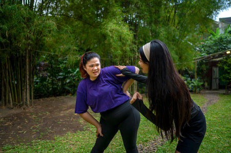 Indonesian southeast asian women in a sporty outfit encouraging her friend while running exercise in...