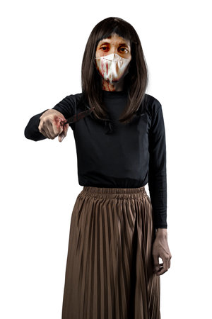 Indonesian southeast asian man dressed as a woman wearing a bloody face mask and holding a bloody knife isolated over a white background. Concept of Halloween, Sister Hong, or red uncleの写真素材