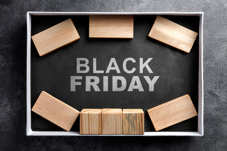 Closeup view of an open box showing Black Friday text on a black background. Flat lay. Black Friday sale conceptの写真素材