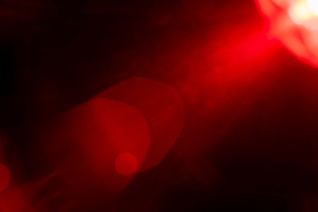 Abstract background featuring blurred, defocused light with a bokeh overlay effect, creating a...