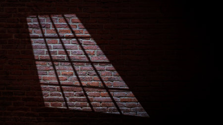 Dramatic shadow of window light casting on the brick wall texture. Copy space. Textured backgroundの写真素材