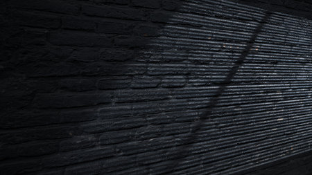 Dramatic shadow of window light casting on the brick wall texture. Copy space. Textured backgroundの写真素材