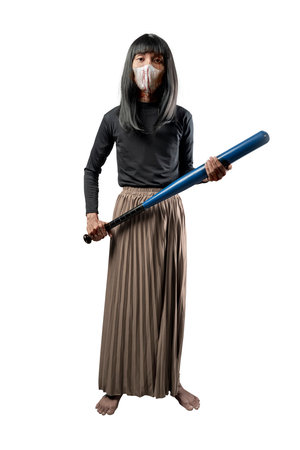Indonesian southeast asian transgender man dressed as a woman wearing a bloody face mask and holding a baseball bat isolated over a white background. Concept of Halloween, Sister Hong, or red uncleの写真素材
