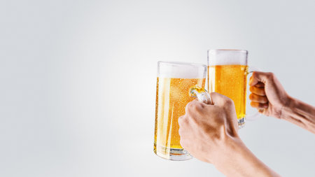 Human hands holding beer mugs isolated over a white background. Oktoberfest festival