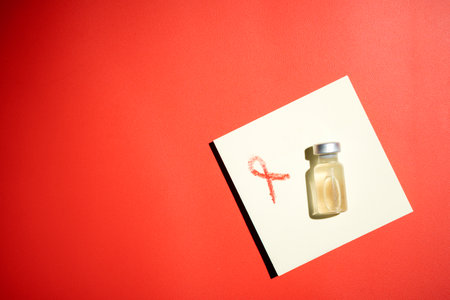 Red ribbon and vial on a red background. Symbolizing awareness and support for HIV or AIDS patients....