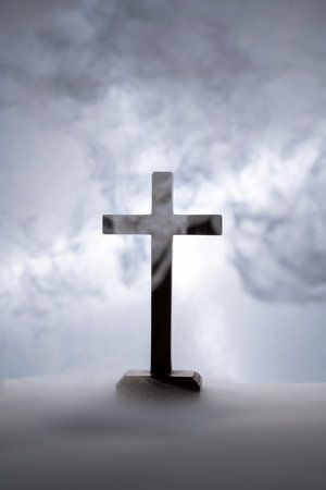 Silhouette of a Christian cross with a smoke background. Concept of Christianity, religious, faith, Jesus, or beliefの写真素材