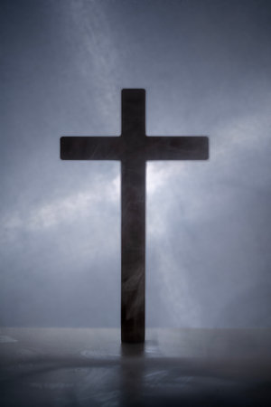 Silhouette of a Christian cross with a light background. Concept of Christianity, religious, faith, Jesus, or beliefの写真素材