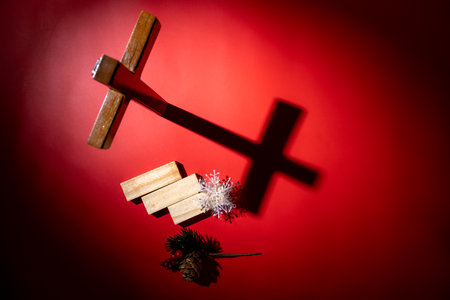 Christian cross with pinecone, and wooden blocks on a red background. Mockup or Copy space. Concept...
