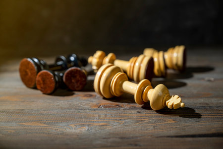Closeup view of fall black and white chess pieces with a dark background. Concept of strategy,...