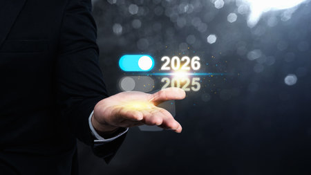 Business hand showing the year 2026 above 2025 on a virtual screen. Happy New Year concept or Celebrationの写真素材