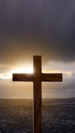 Christian cross with landscape view and dark dramatic sky background. Concept of Christianity, religious, faith, Jesus, or beliefの写真素材