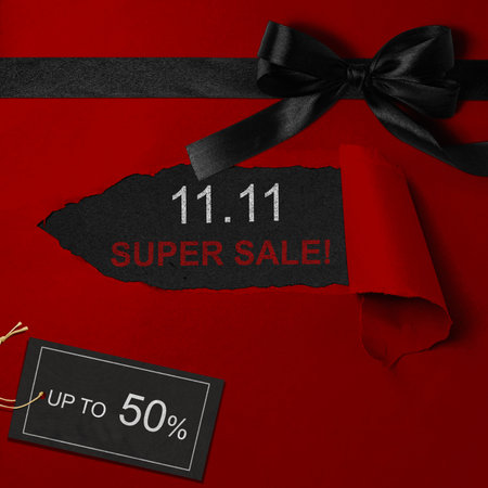 Top view of red ripped paper and text of 11.11 super sale with up to 50% text on the label tag. Copy space. Flash sale conceptの写真素材
