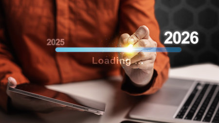 Female hand with laptop and tablet slides the loading bar from 2025 to 2026 on a virtual screen. Happy New Year concept or Celebrationの写真素材