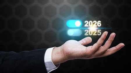 Business hand showing the year 2026 above 2025 on a virtual screen. Happy New Year concept or...