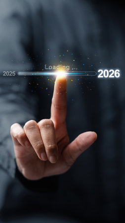 Business hand slides the loading bar from 2025 to 2026 on a virtual screen. Happy New Year concept or Celebrationの写真素材