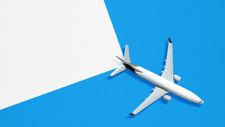 Airplane with a split blue and white background. Template or Copy space. Concept of travel, tourism...
