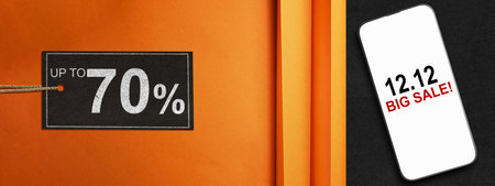 12.12 big sale text on cellphone screen with up to 70% text on the label tag. Copy space. Flash sale conceptの写真素材