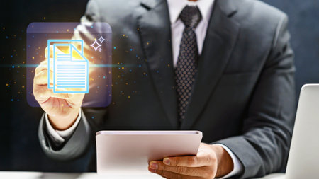 Professional businessman interacts with a glowing digital document icon using a tablet, illustrating paperless office solutions, cloud storage, and modern business data managementの写真素材