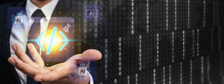 Businessman holding a glowing code symbol with AI icons on a binary background. Concept for artificial intelligence in software development, programming, and digital transformationの写真素材