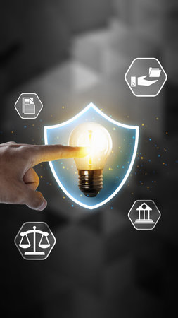Hand touching a glowing lightbulb inside a shield, surrounded by legal icons. Represents...