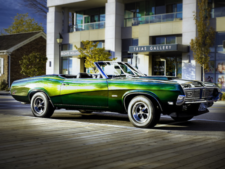 Classic green convertible car parked on the street with the top down.のeditorial素材