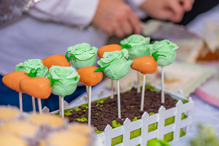 Beautiful candy arrangement with vibrant colors and shapes with a person working on the background.の写真素材