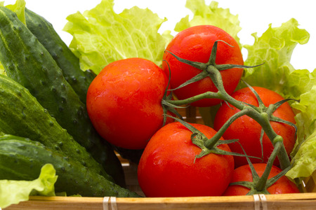 cucumbers, tomatoes, lettuce in the basket. health foodの写真素材