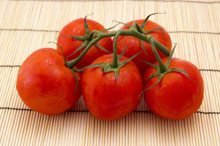 tomatoes with sprigs on wooden background. healthy food
の写真素材