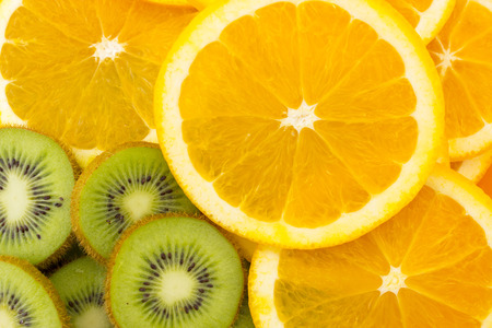 Fruity background set of slices of orange fruit and kiwi. Many slices of kiwi fruit and orange fruit, Fresh kiwis and orange fruit, interesting fruit compositionの写真素材