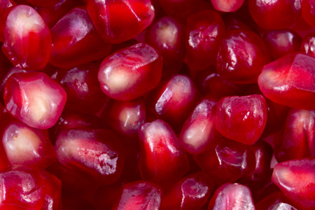 macro of pomegranate seeds for backgrounds. Loose pomegranate (Punica granatum) seeds. Pomegranates are widely used in middle eastern and Mediterranean culture. Pomegranates are a super food.の写真素材
