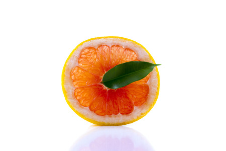 fresh grapefruit with leaves isolated on white backgroundの写真素材