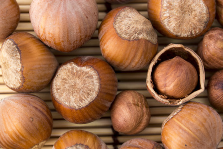 nuts, hazelnuts as background. Filberts on a wooden table. Close-up shot.の写真素材