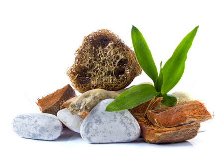 Spa and wellness setting with towel, bamboo, wooden parts, natural loofah sponge on a white background with clipping pathの写真素材