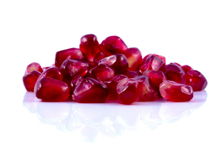 Macro peeled ripe pomegranate fruit with water droplets. isolated on white backgroundの写真素材