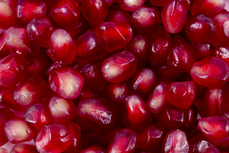 macro of pomegranate seeds for backgrounds. Loose pomegranate (Punica granatum) seeds. Pomegranates are widely used in middle eastern and Mediterranean culture. Pomegranates are a super food.の写真素材