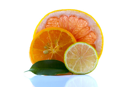 Mixed citrus sliced ââfruit. Orange, lime and grapefruit as batskground. Isolated on white backgroundの写真素材