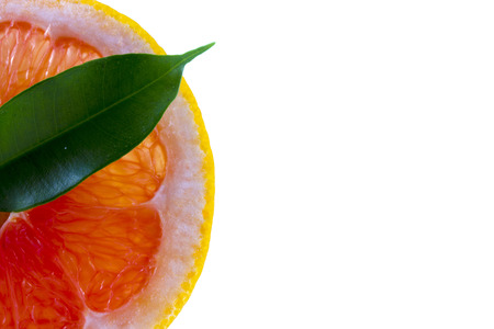 fresh grapefruit with leaves isolated on white backgroundの写真素材
