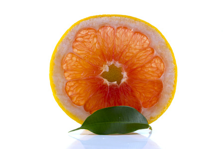 fresh grapefruit with leaves isolated on white backgroundの写真素材
