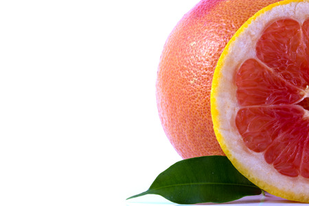fresh grapefruit with leaves isolated on white backgroundの写真素材