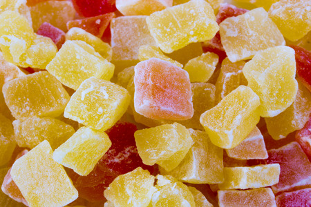 Dried fruits closeup. Yellow and orange dried papaya slices backgroundの写真素材