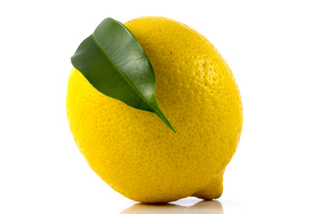 Single ripe lemon with green leaf isolated on white backgroundの写真素材