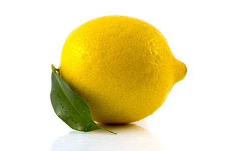 Single ripe lemon with green leaf isolated on white backgroundの写真素材