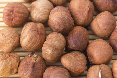 nuts, hazelnuts as background. Filberts on a wooden table. Close-up shot.の写真素材