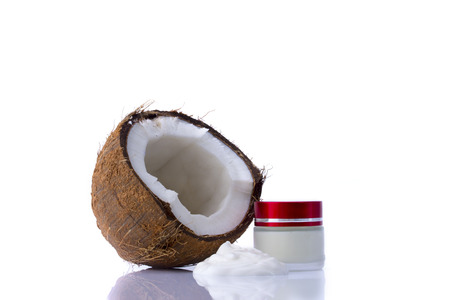 Shredded coconut and box with cream on white backgroundの写真素材