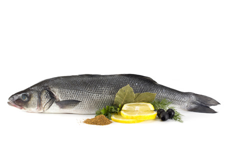Seabass with with spices, parsley, dill and lemon isolated on white backgroundの写真素材