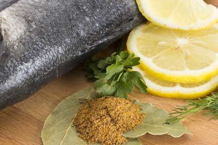 Seabass with with spices, parsley, dill and lemon isolated on white backgroundの写真素材